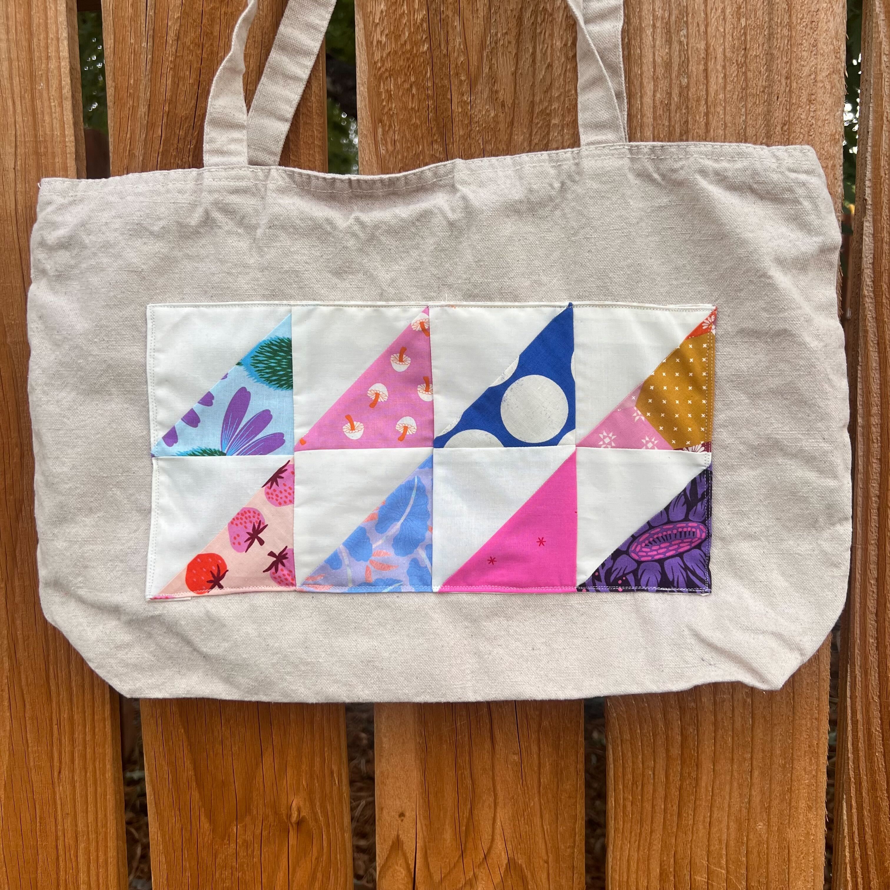 Tote bag with quilt block sewn on.